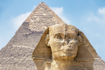Fototapeta na wymiar Spinx face on the Giza pyramid background, Cairo, Egypt