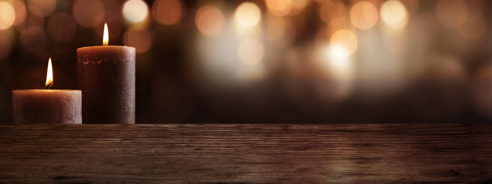 Candles with wooden table and bokeh background