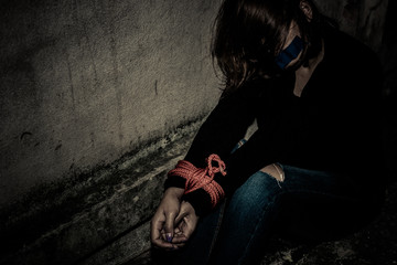Asian hostage woman Bound with rope at night scene,The thieves kidnapped for ransom,thailand people