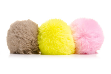Fur balls yellow pink brown on white background isolation