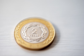 Macrophotography of two Argentine pesos coin on a white background