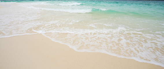 Soft beautiful ocean wave on sandy beach. Background.