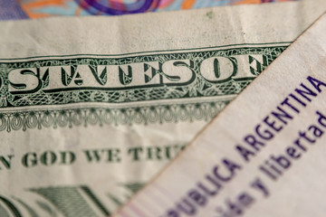 Macrophotography of an Argentine 100 pesos bill and one dollar (United States of Argentina)