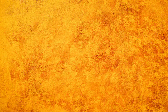Textured orange painted concreet wall, abstract background