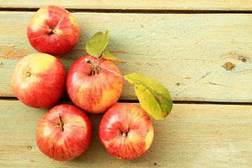 Delicious apples harvested in autumn presented on a rustic surface