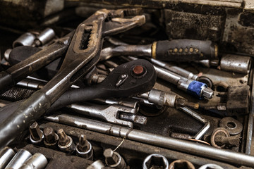 Set of metal tools in mess. Background with limited depth of field.