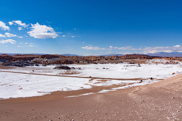 Sand dunes with salt deposits in the Atacama Desert, Chile on a sunny day with blue sky