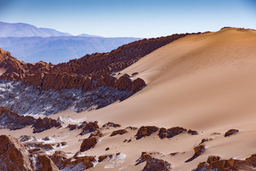 Sand dunes with salt deposits in the Atacama Desert, Chile on a sunny day with blue sky