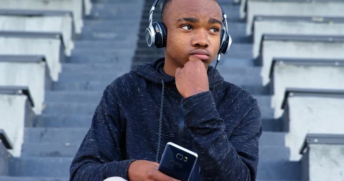 Disabled African American man athletic listening music on mobile phone 4k