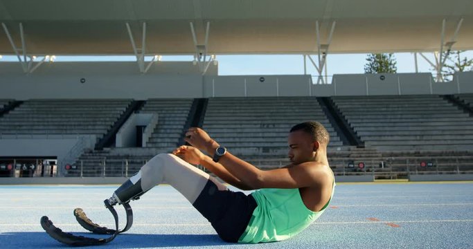 Disabled athletic exercising on a running track 4k