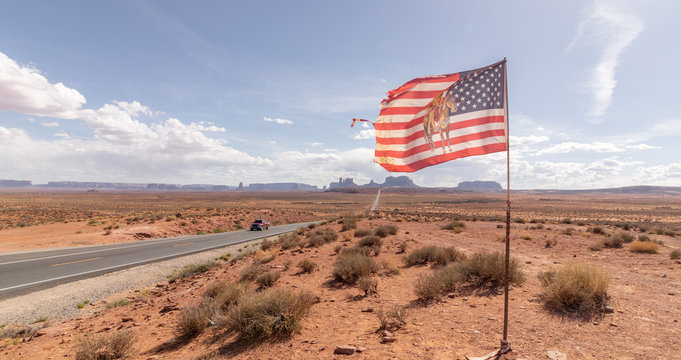 image of a truck and the American Flag in the famous road to Monument Valley