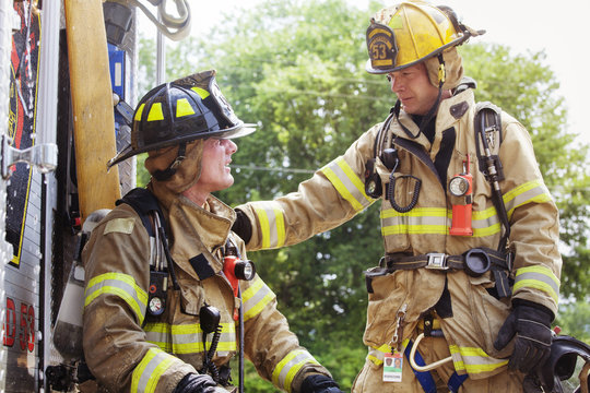 Two firefighters talking