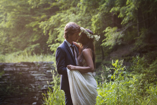 Affectionate couple kissing in forest