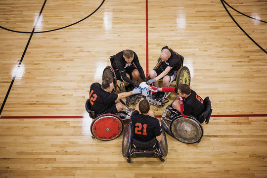 High angle view of disabled basketball players touching ball
