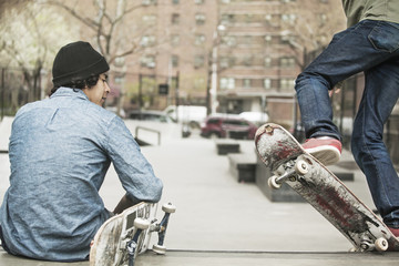 Two young men at skateboard park © Cavan for Adobe