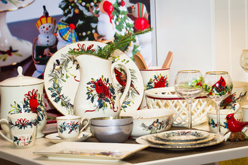 Christmas table, festive Christmas table setting, elegant dishes, Christmas houses and candles. Beautiful decor.
