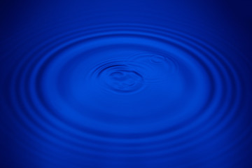 Closeup blue wave water rings macro, Circle reflections in pool.