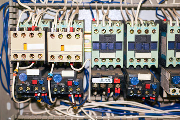 Fototapeta premium Several old relays with connected colored wires.