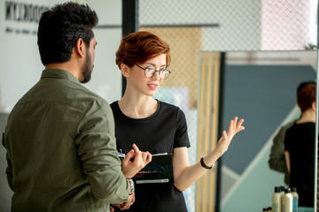 Two business people discussing about work in office