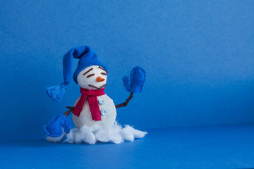 Comical snowman on blue background. Winter traditional snowman character with scarf mittens blue hat. Xmas new year holidays greeting poster template. Copy space