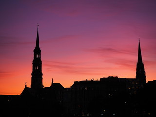 Hamburg silhouette of the city and bell towers with pink and red sunset