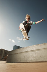 Low angle view of man jumping with skateboard at park © Cavan for Adobe