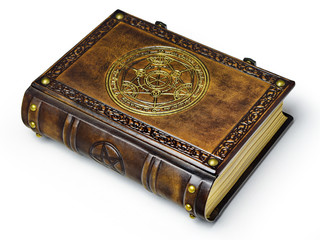Leather book with gilded transmutation circle in center of the front cover, attributed to a German alchemist from the 17th century. Captured isolated while laying on the table from the left side.