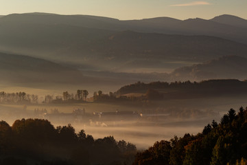 Sunset in mountain landscape. Mountain layers in sunset. Sunset in the mountain forest landscape. Forest and mountains landscape