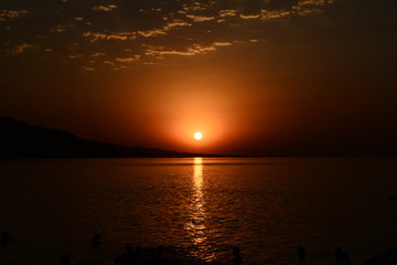 Beautiful blazing sunset landscape at Caspian Sea and orange sky above.