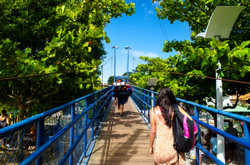 Woman crossing a bridge