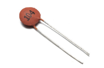 Ceramic capacitor on white background, macro shot