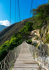Wood bridge over forest valley in Hidalgo Mexico