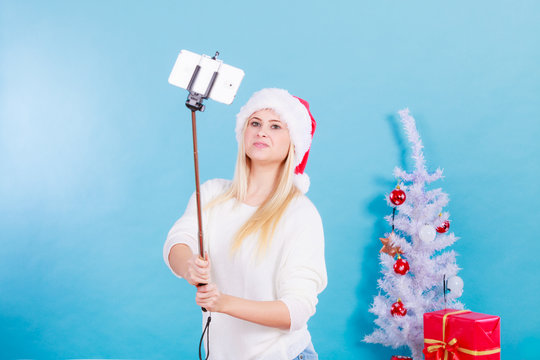 Woman in santa hat taking selfie