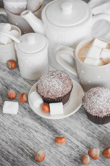 Cacao, chocolate cupcakes, hazelnuts and different decorations