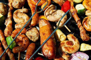 Assorted types of meat and vegetables on the grill