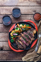 Grilled Beef Steak on grill iron pan on wooden background