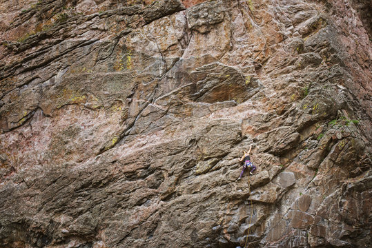 Woman climbing rock