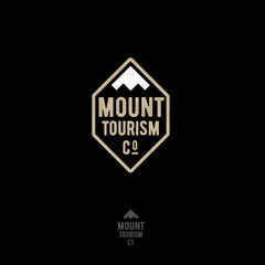 Mountain tourism logo. Climbing club. Mountain peaks and letters. Emblem for sportswear, mountaineering. Winning the competition icon.