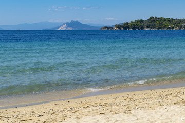 Beautiful view from Vromolimnos beach on Skiathos island toward Evia island in Greece