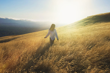 Rear view of female standing on field © Cavan for Adobe