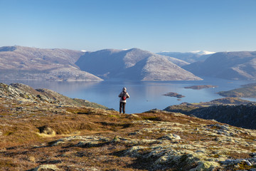 Woman on autumn hike on the Skomo mountain in Bronnoy municipality Northern Norway