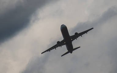 Silhouette of a plane taking off against the blue sky