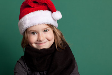 Happy Christmas Girl in Santa Hat, Isolated on Green