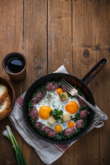 Frying pan with tasty cooked egg and sausages on table, copy space