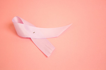 Pink ribbons symbolic bow color for Breast cancer awareness in October month on pink background