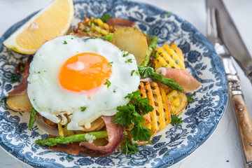 Fried egg with potato and jamon ham, spain cuisine, close view
