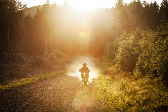 Man riding motorcycle on gravel road