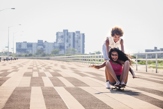 Friends skateboarding on pier