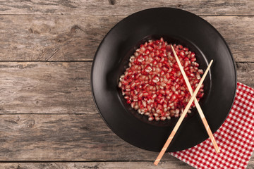 pomegranate plate over wooden table