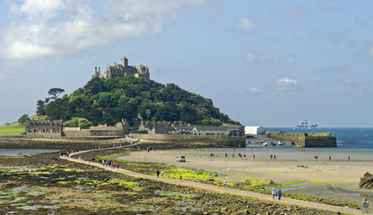 Tourists crossing over the exposed causeway at low tide betwen the tidal island of St. Michael's...